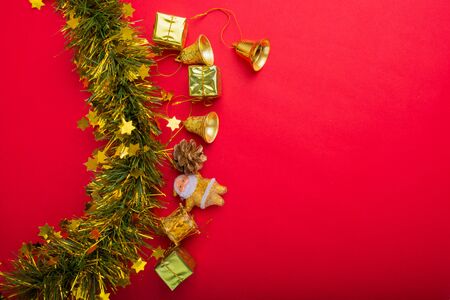 Christmas decoration with red and gold background.top view, copy space.Gift box,Santa clause,Branch pine,Stars,Bell.の写真素材