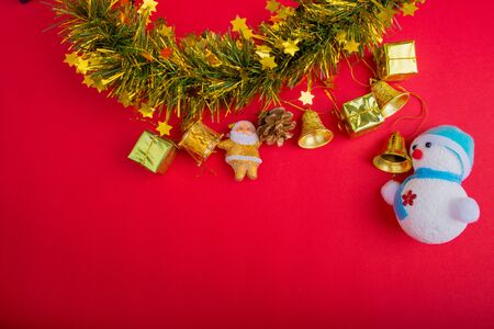 Christmas decoration with red and gold background.top view, copy space.Gift box,Santa clause,Branch pine,Stars,Bell,Snowmanの写真素材