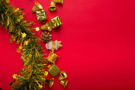 Christmas decoration with red and gold background.top view, copy space.Gift box,Santa clause,Branch pine,Stars,Bell.の写真素材
