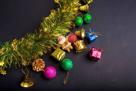 Christmas decoration with dark black background.top view, copy space. Ball,Gift box ,Santa clause,Ribbon,Branch pine,bell.の写真素材