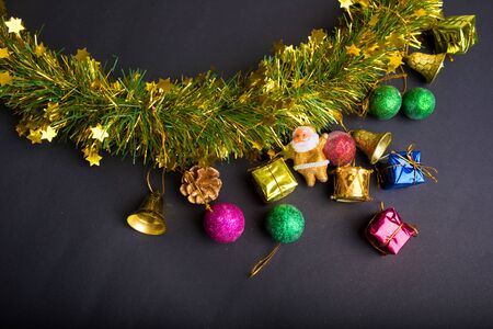 Christmas decoration with dark black background.top view, copy space. Ball,Gift box ,Santa clause,Ribbon,Branch pine,bell.の写真素材