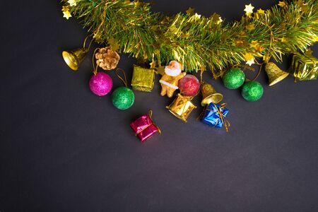 Christmas decoration with dark black background.top view, copy space. Ball,Gift box ,Santa clause,Ribbon,Branch pine,bell.の写真素材