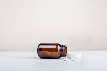 Bottles of food supplements and supplements outside the bottles set on white background.の写真素材