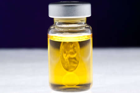 Get Your Money's worth of medication. A floating coin inside a medication vial ready for use.の写真素材