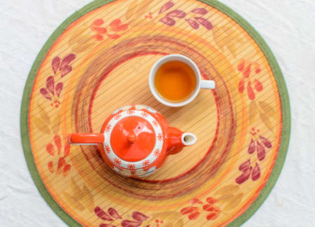 Cup of tea and teapot on wood padの写真素材