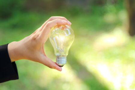 businesswoman holding electric glass bulb, idea for business innovation and inspiration concept using as backgroundの写真素材