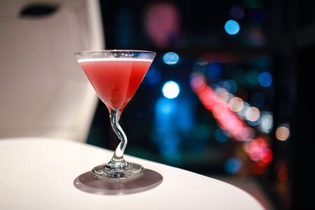 blur image of cocktail glass with city view at nightの写真素材