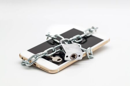smart phone with chain lock and money isolated, idea for technology with securityの写真素材