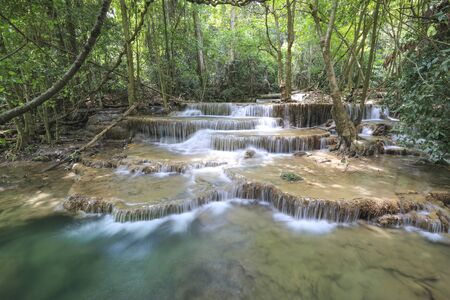 water fall in nature with green trees in Kanchanaburi, Thailandの写真素材
