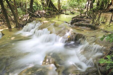 water fall in nature with green trees in Kanchanaburi, Thailandの写真素材