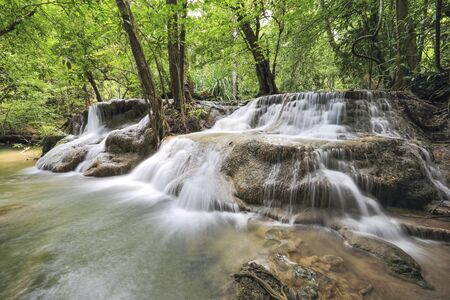 water fall in nature with green trees in Kanchanaburi, Thailandの写真素材