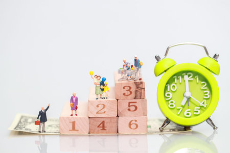 Miniature people: businessman standing on wood block stacking, Financial and Business growth concept...