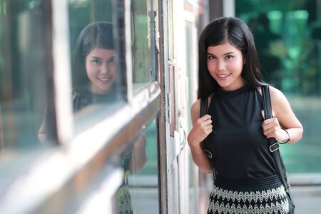 portrait of beautiful woman standing outdoor with womanâs handbag (this image for people freedom concept)の写真素材