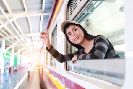 Young traveler woman looking out the windowの写真素材