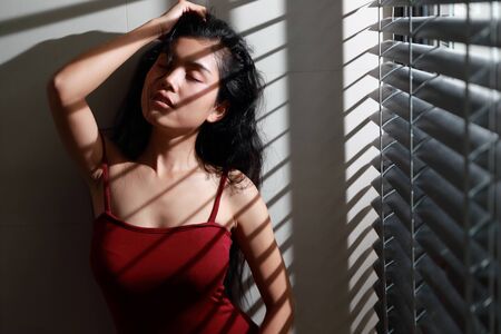portrait of beautiful and sexy woman with window lightの写真素材