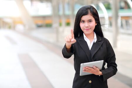 businesswoman using tablet and pointing fingureの写真素材