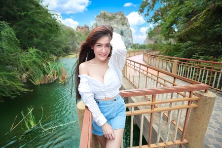portrait of beautiful woman in nature outdoors with smilingの写真素材