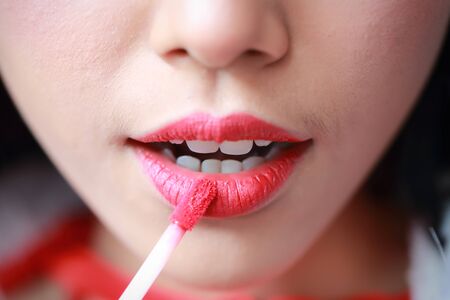 young asian santa girl applying lipstick on beautiful faceの写真素材