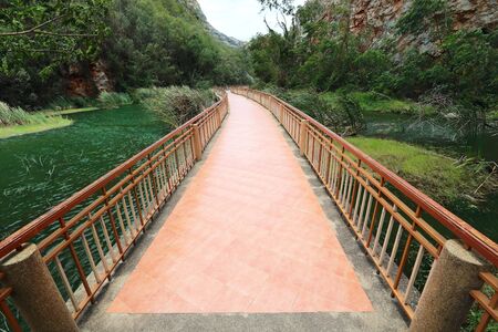 image of walkway with nature and mountain at Ngu Stone Park, Ratchaburi, Thailandの写真素材