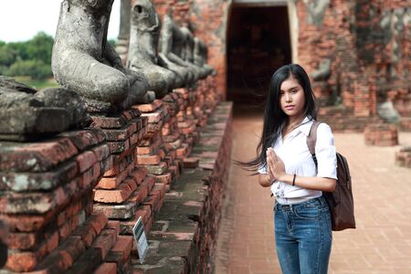 portrait of beautiful traveler asian woman paying respect in ancient templeの写真素材