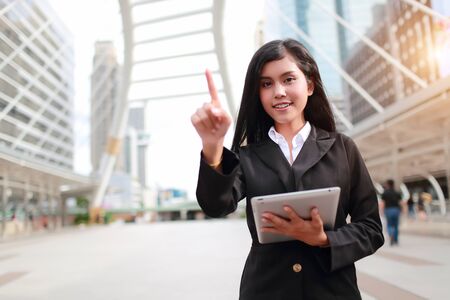 businesswoman using tablet and pointing fingureの写真素材