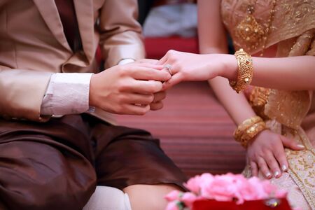 wedding ring on human hand (Thai culture)の写真素材