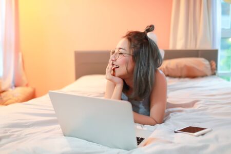 beautiful and sexy woman using laptop computer before go to sleepの写真素材