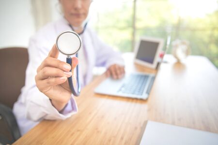 doctor portrait posting checking patient heart beat (medical concept)の写真素材