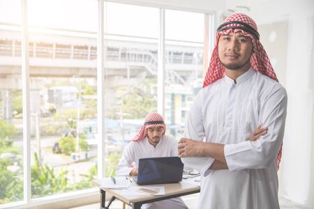 arab saudi businessman portrait with employee backgroundの写真素材