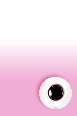 top view pink gradient working desk with black coffeeの写真素材