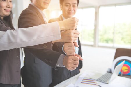 portrait business people stacking hand together using as background (concept of teamwork and partnership)の写真素材