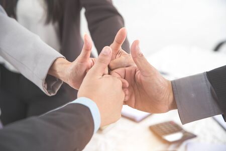 business people giving thumb up after completed project during meeting using as background (concept of teamwork and partnership)の写真素材