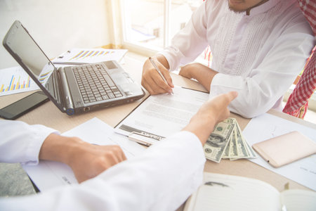 arab saudi businessman signing contract using as business background (concept of teamwork and...