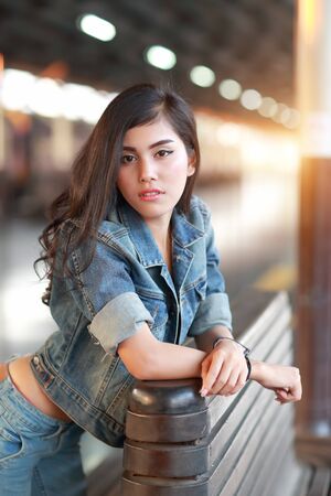 young traveler woman with backpack waiting for trainの写真素材