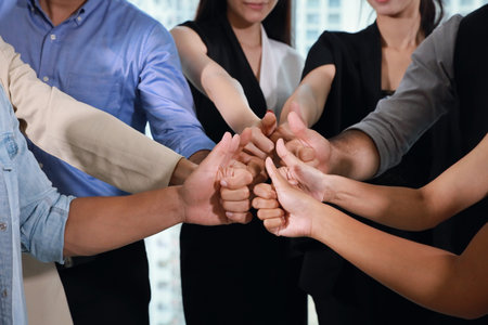 Close up of multiethnic business people hands thumb up together meaning of teamwork or success...