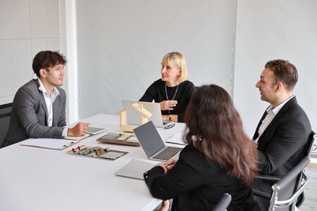 Multiethnic business people discussing company about new house project in meeting room with smiling and happy facesの写真素材