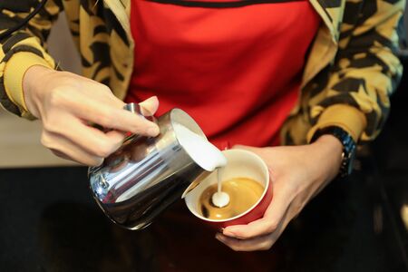 young trainee barista girl hands making coffeeの写真素材