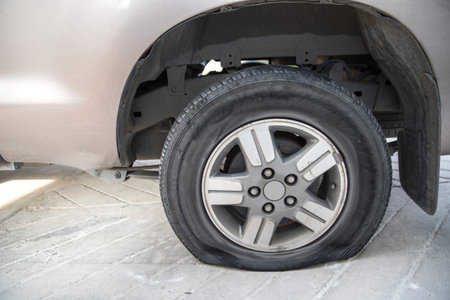 abandon car with flat tire and tire burst from accident on the road