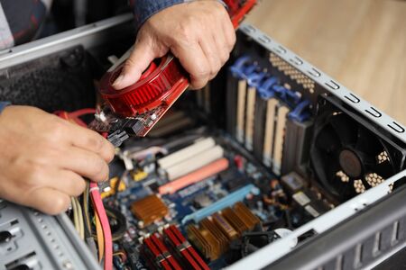 technician man fix or upgrading VGA card on computerの写真素材