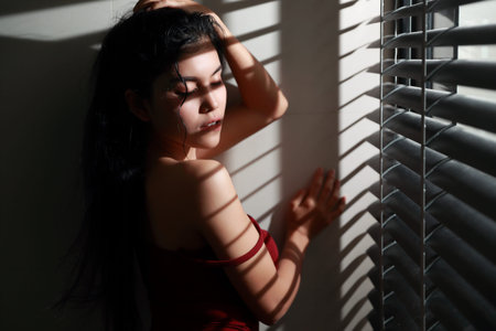 portrait of beautiful and sexy woman with window light (dark filter effect)