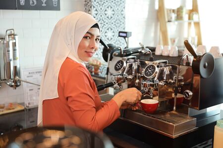 young muslim barista girl hands making coffeeの写真素材