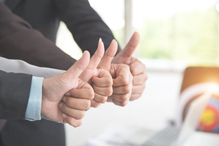 business people giving thumb up after completed project during meeting using as background (concept...
