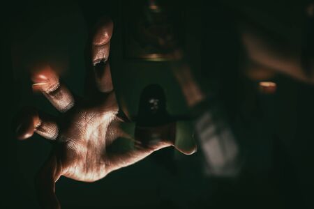 blurry image and double exposure ghost woman hand in haunted hotel with dark filter, halloween conceptの写真素材