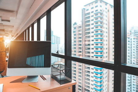 modern office with computer on wood desk, office supplies and coffee cup