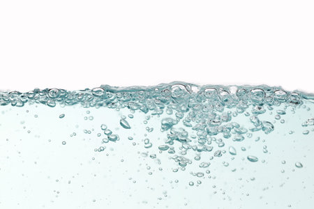 Close up blue water splash with air bubbles on white background isolated. Advertising image with...