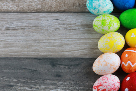 Group colorful and decorated easter eggs on vintage wooden table background. Advertising image...