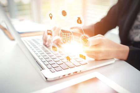 woman hands holding credit card and using laptop computer shopping online with graphic icon