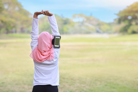 Public exercise lifestyle concept, fitness woman listening music from wireless earphones and mobile...