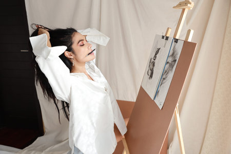 side view woman artist in white shirt drawing picture with pencil (woman lifestyle concept)