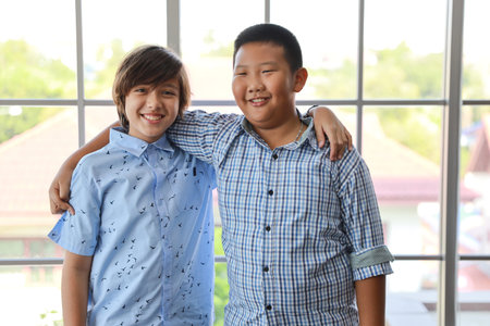 Multiethnic smart boys portrait in casual dress with confident and standing in classroom with happy...